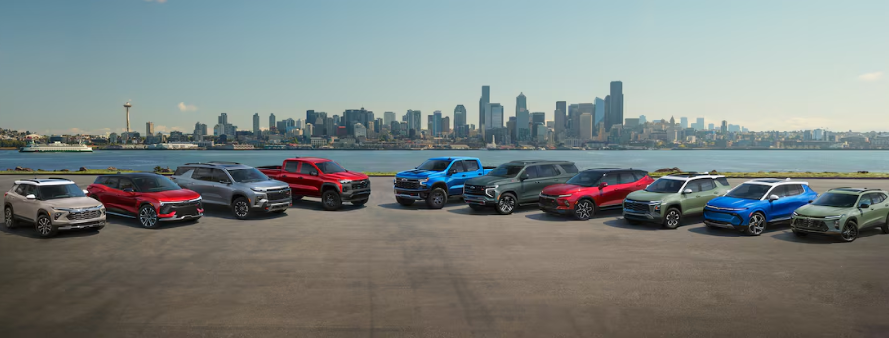 A lineup of efficient Chevrolet vehicles driving on a scenic road