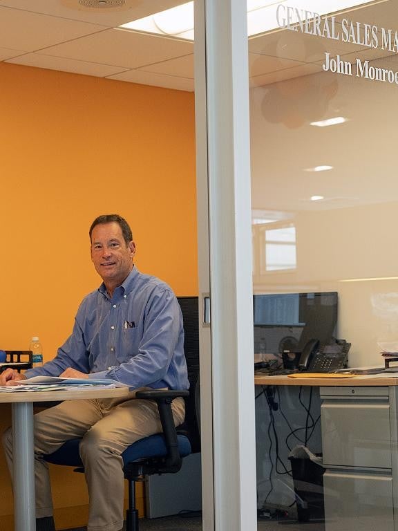 two pictures merged of finance employees seating on desk